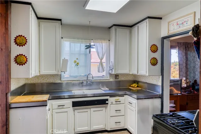 a kitchen with stainless steel appliances granite countertop a sink and a stove