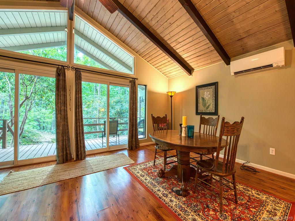 276 Hideaway Creek Road Clyde, NC 28721 - Photo 14 of 32 a dining room with furniture and wooden floor