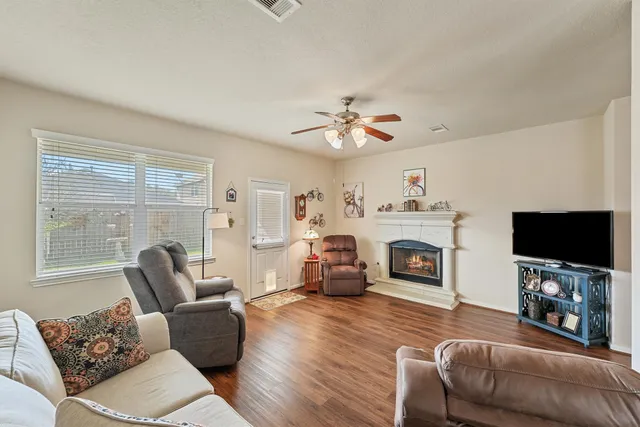 a living room with furniture a fireplace and a flat screen tv