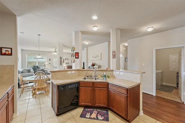 a kitchen with a sink stove and cabinets