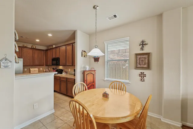 a dinning room and kitchen with a decorative lights