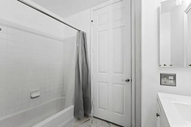 a bathroom with a shower and a bath tub