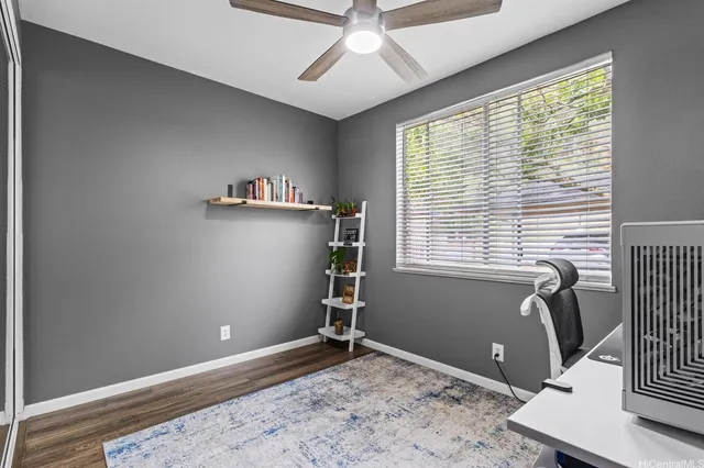 a view of a workspace with furniture and a window