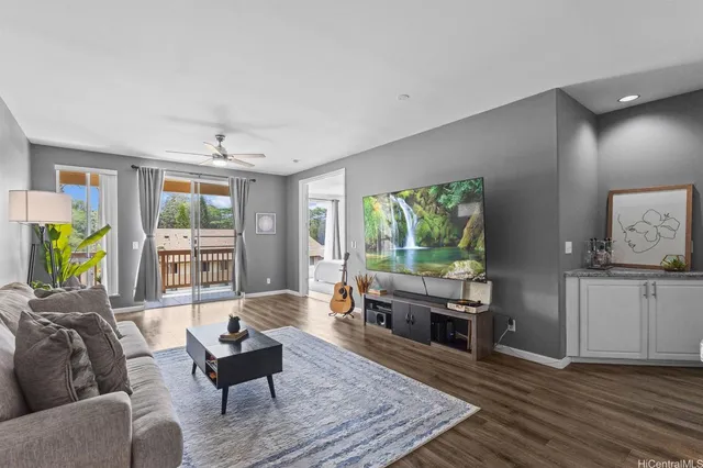a living room with furniture and a wooden floor