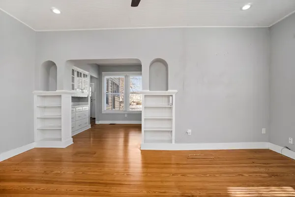 a view of living room with cabinets and wooden floor