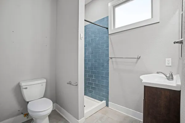 a white toilet sitting next to a bathroom sink