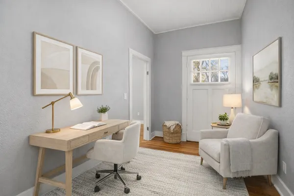 a living room with furniture and a potted plant