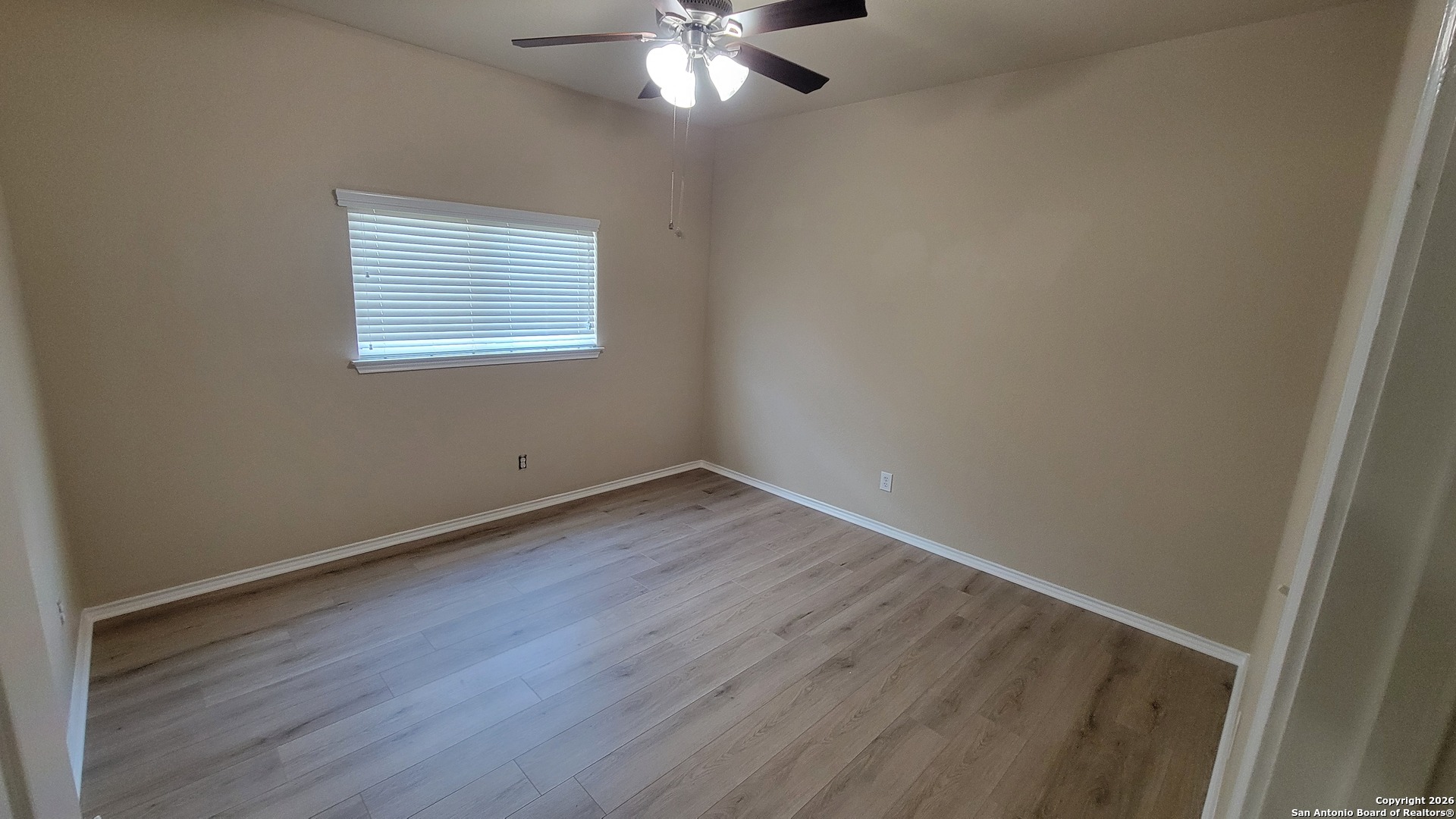26311 Presidio Boerne, TX 78015 - Photo 14 of 16 an empty room with wooden floor and windows