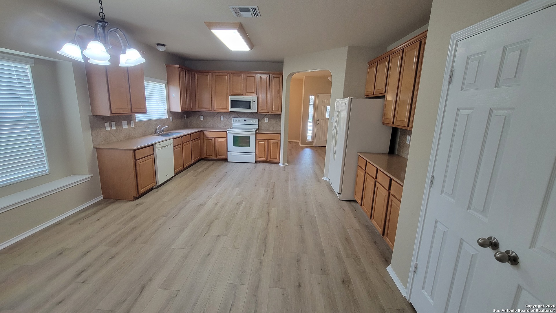 26311 Presidio Boerne, TX 78015 - Photo 7 of 16 a kitchen with a refrigerator a sink and wooden floor