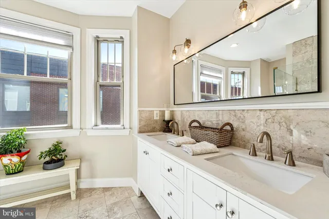 a bathroom with a sink mirror and vanity
