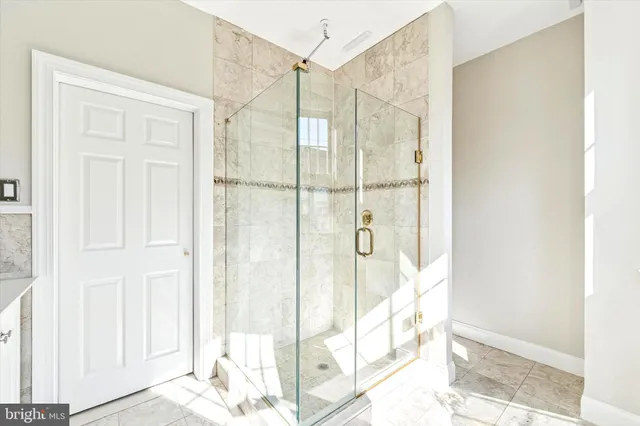 a view of a bathroom with a shower and a window