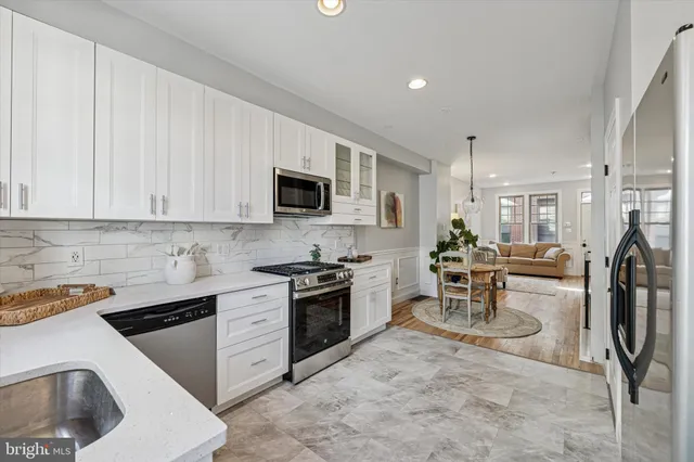 a kitchen with appliances a sink and cabinets