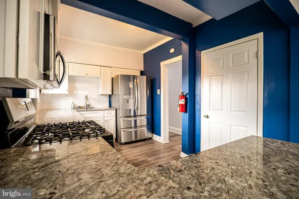an empty room with wooden floor and closet