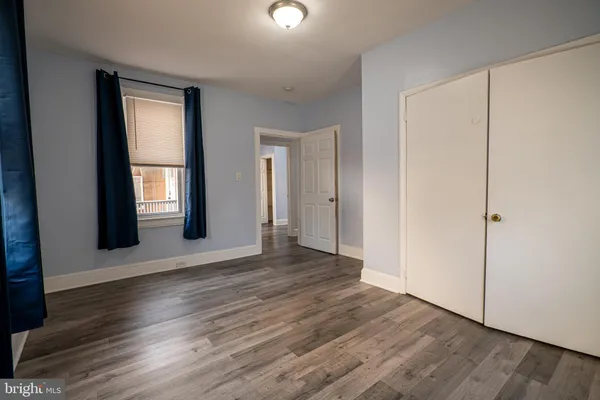 a view of a white house with a large tree