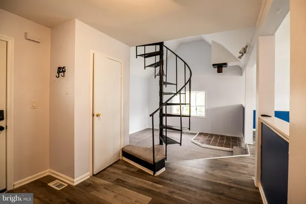 a view of a big room with wooden floor windows and a kitchen