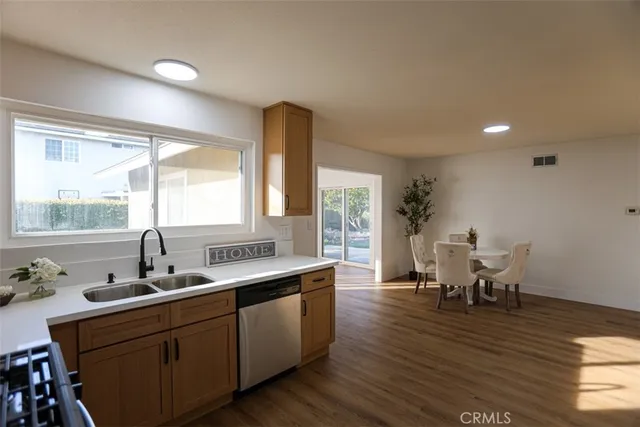 a kitchen with sink cabinets and wooden floor