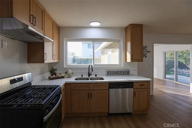 a kitchen with a sink stove and cabinets