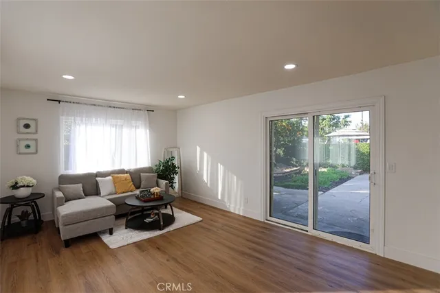 a living room with furniture window and wooden floor