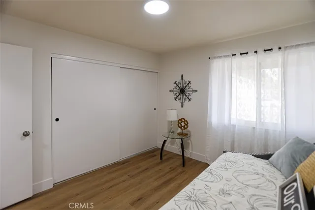 a bedroom with a bed and wooden floor