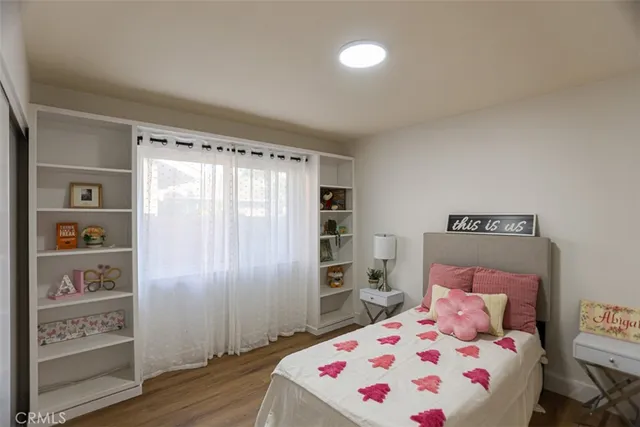 a bedroom with a bed and a large mirror