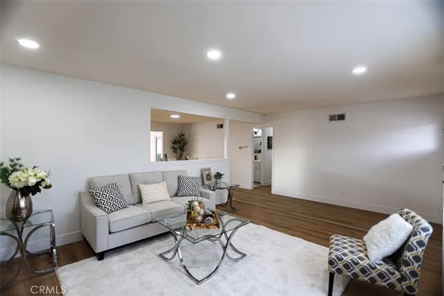 a living room with furniture and flowers