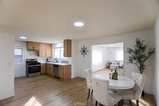 a large kitchen with a table and chairs in it