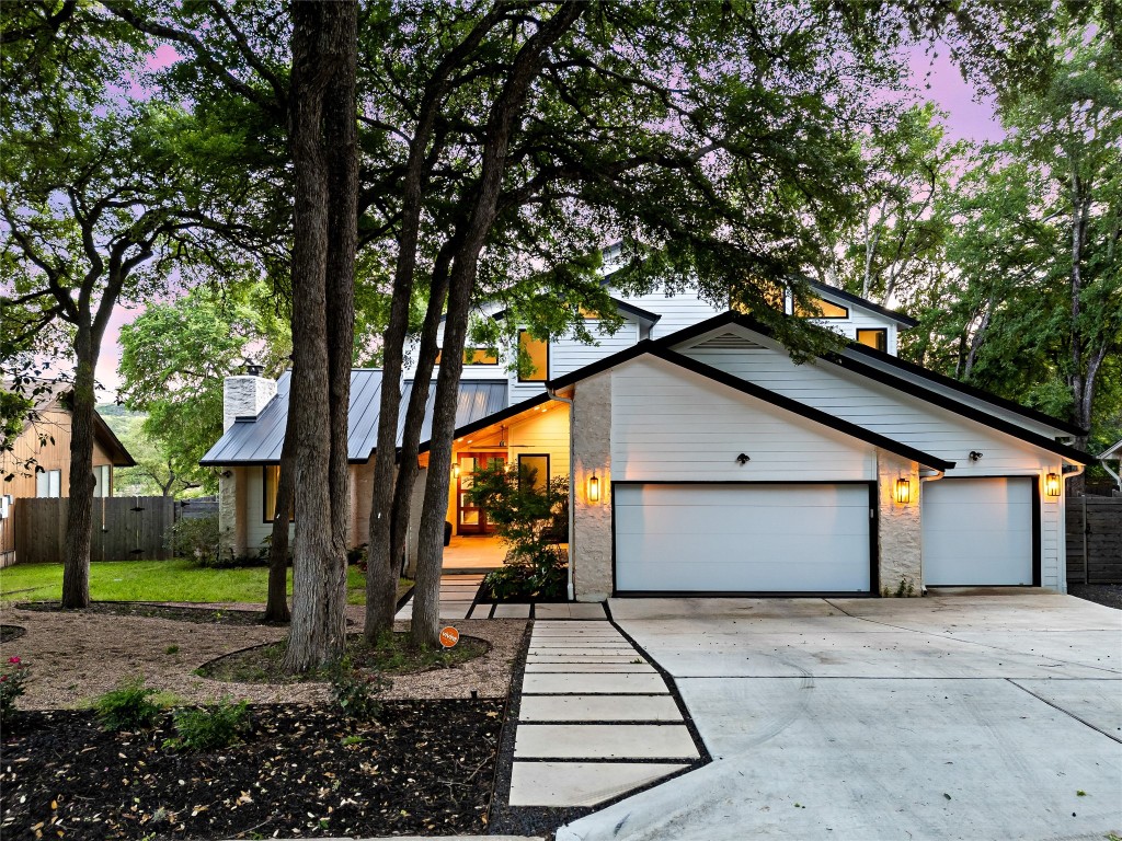 a view of a house with a yard and tree s