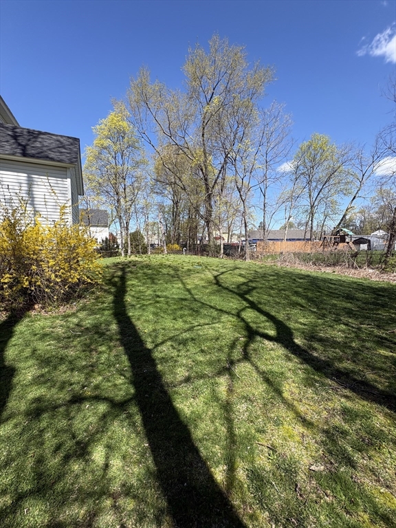 22 Goldsmith Street Littleton, MA 01460 - Photo 2 of 4 a view of a big yard with plants and large trees