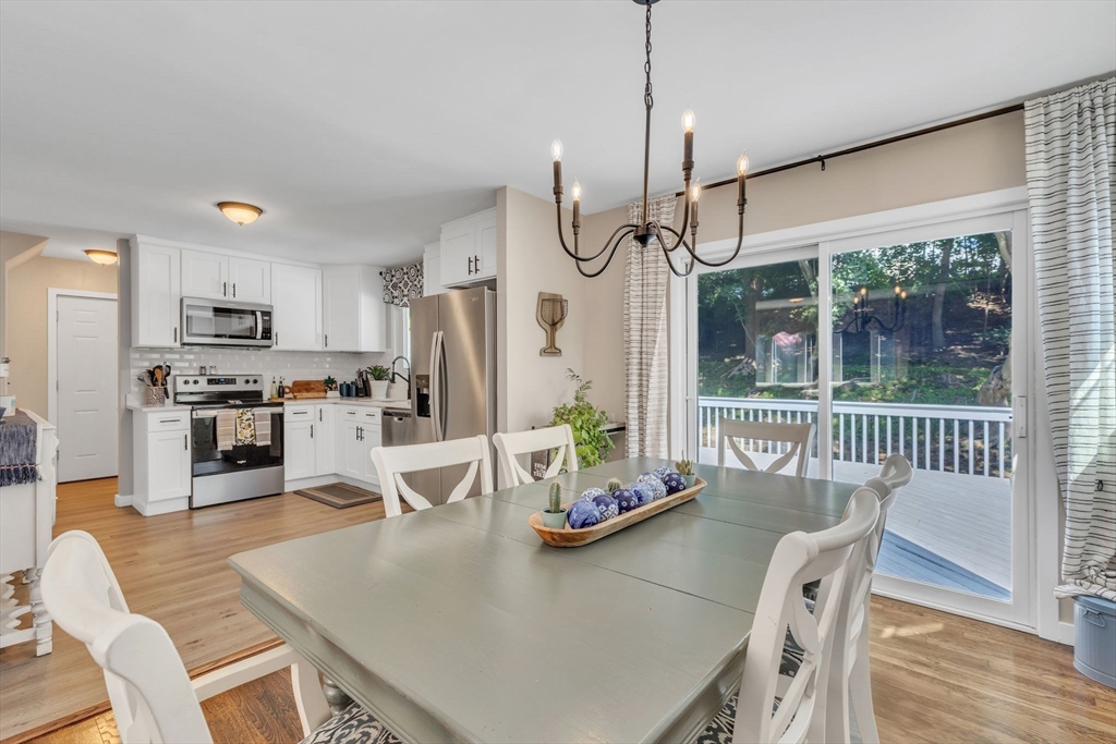 336 Taylor Road Enfield, CT 06082 - Photo 11 of 30 a dining room with furniture a chandelier and wooden floor