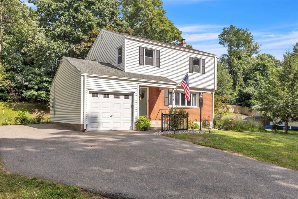 336 Taylor Road Enfield, CT 06082 - Photo 3 of 30 a front view of a house with a garden and trees