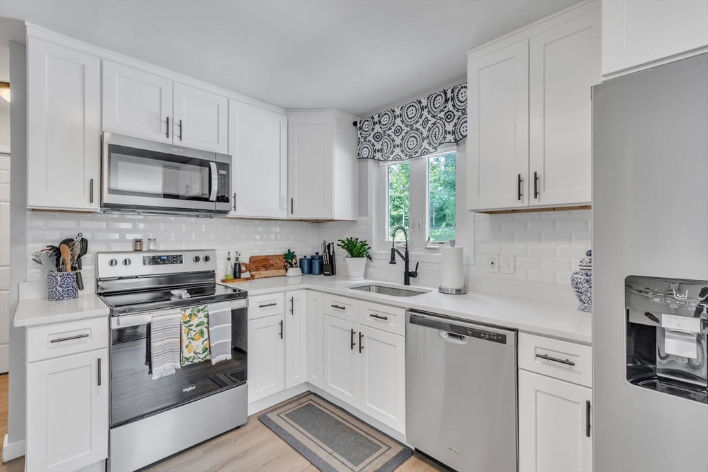 336 Taylor Road Enfield, CT 06082 - Photo 5 of 30 a kitchen with stainless steel appliances granite countertop a sink and stove top oven