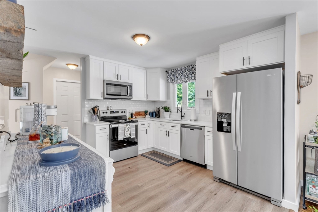336 Taylor Road Enfield, CT 06082 - Photo 7 of 30 a kitchen with white cabinets and stainless steel appliances