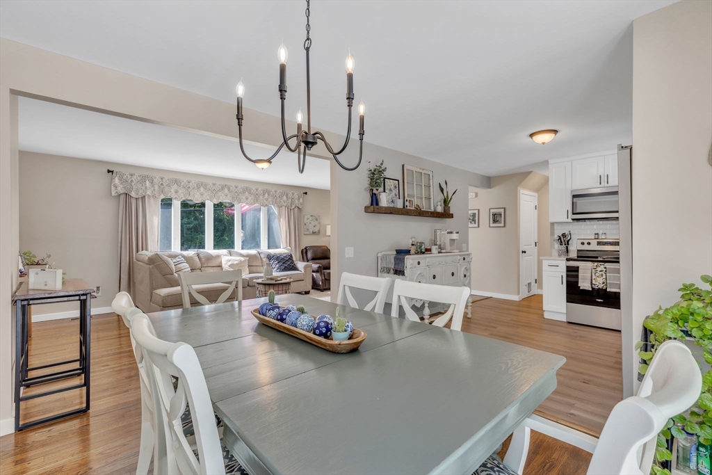 336 Taylor Road Enfield, CT 06082 - Photo 10 of 30 a view of a dining room and livingroom with furniture wooden floor kitchen chandelier