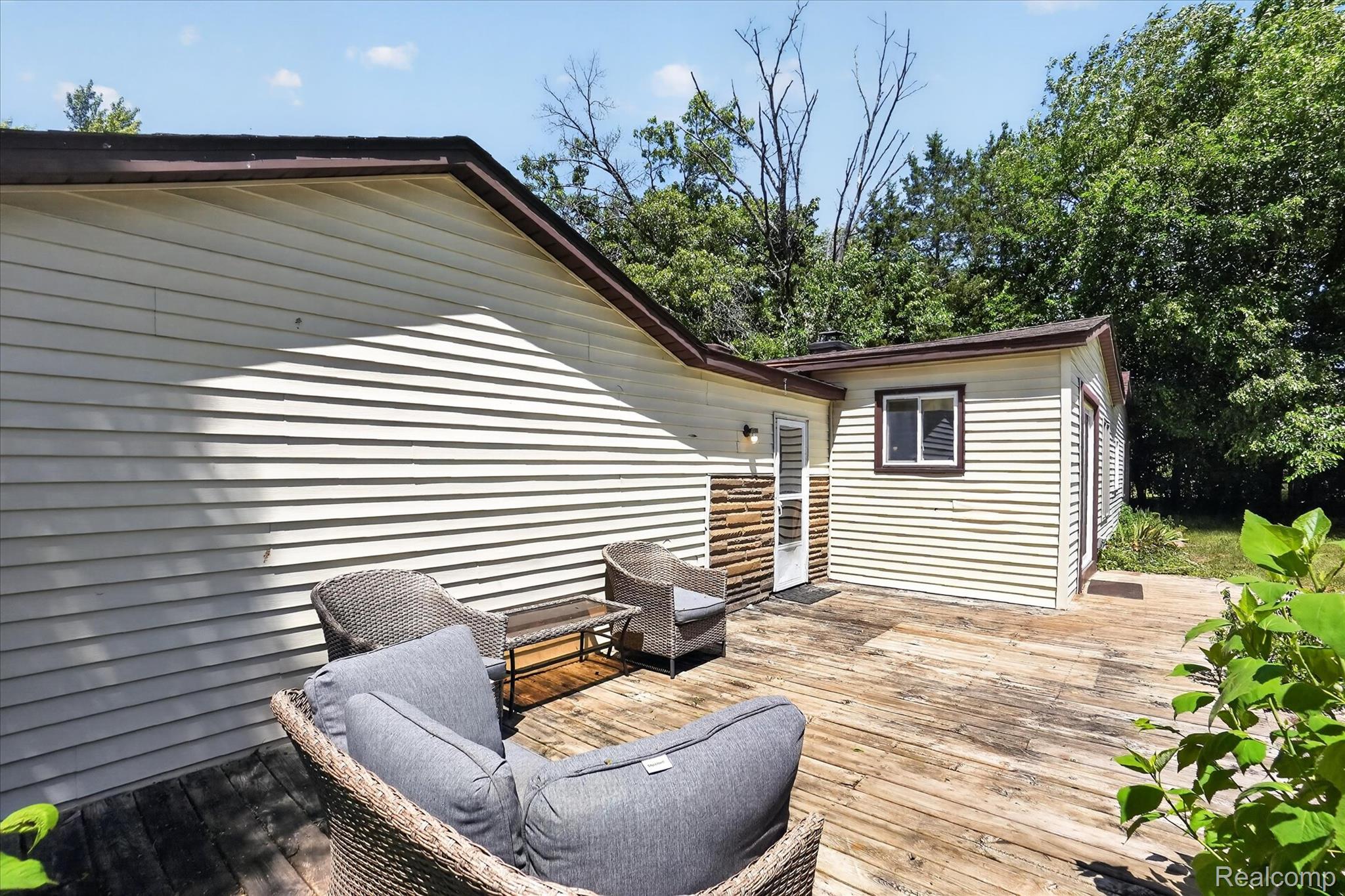 508 Deland Road Flushing, MI 48433 - Photo 33 of 38 Expansive outdoor decking featuring natural wood planks