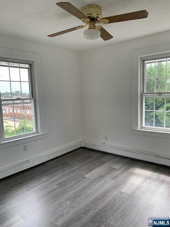 73 East Gouverneur Avenue Rutherford, NJ 07070 - Photo 21 of 33 an empty room with wooden floor fan and windows