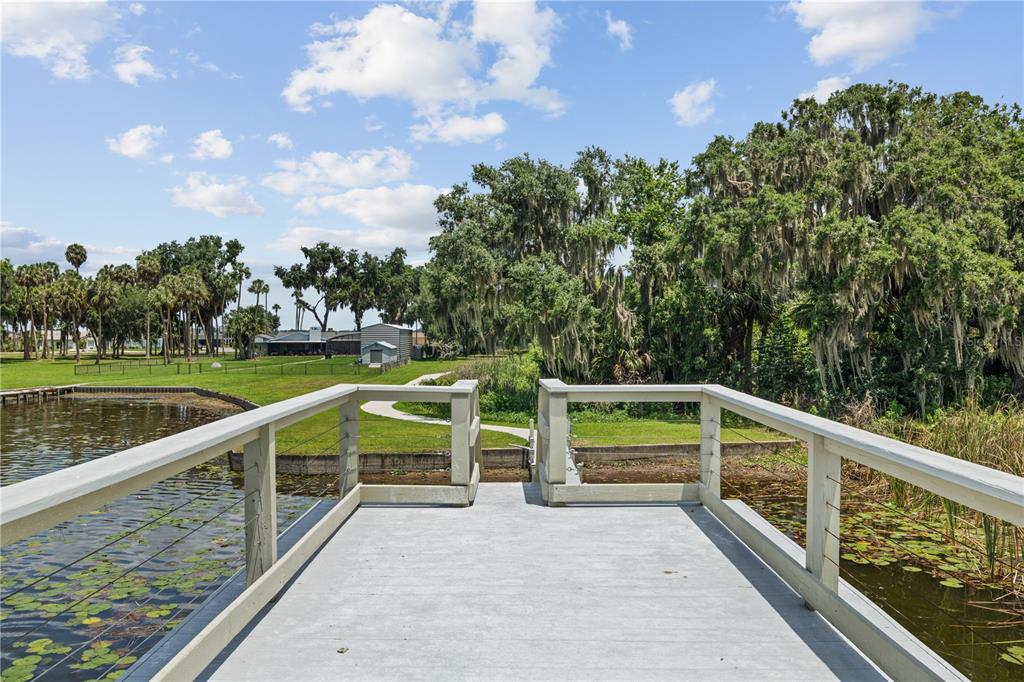 16948 Deer Island Road Tavares, FL 32778 - Photo 62 of 67 a view of balcony with wooden floor and fence