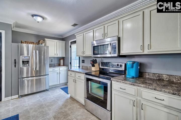 209 Eagle Pointe Drive Chapin, SC 29036 - Photo 13 of 40 a kitchen with stainless steel appliances granite countertop a refrigerator stove and microwave