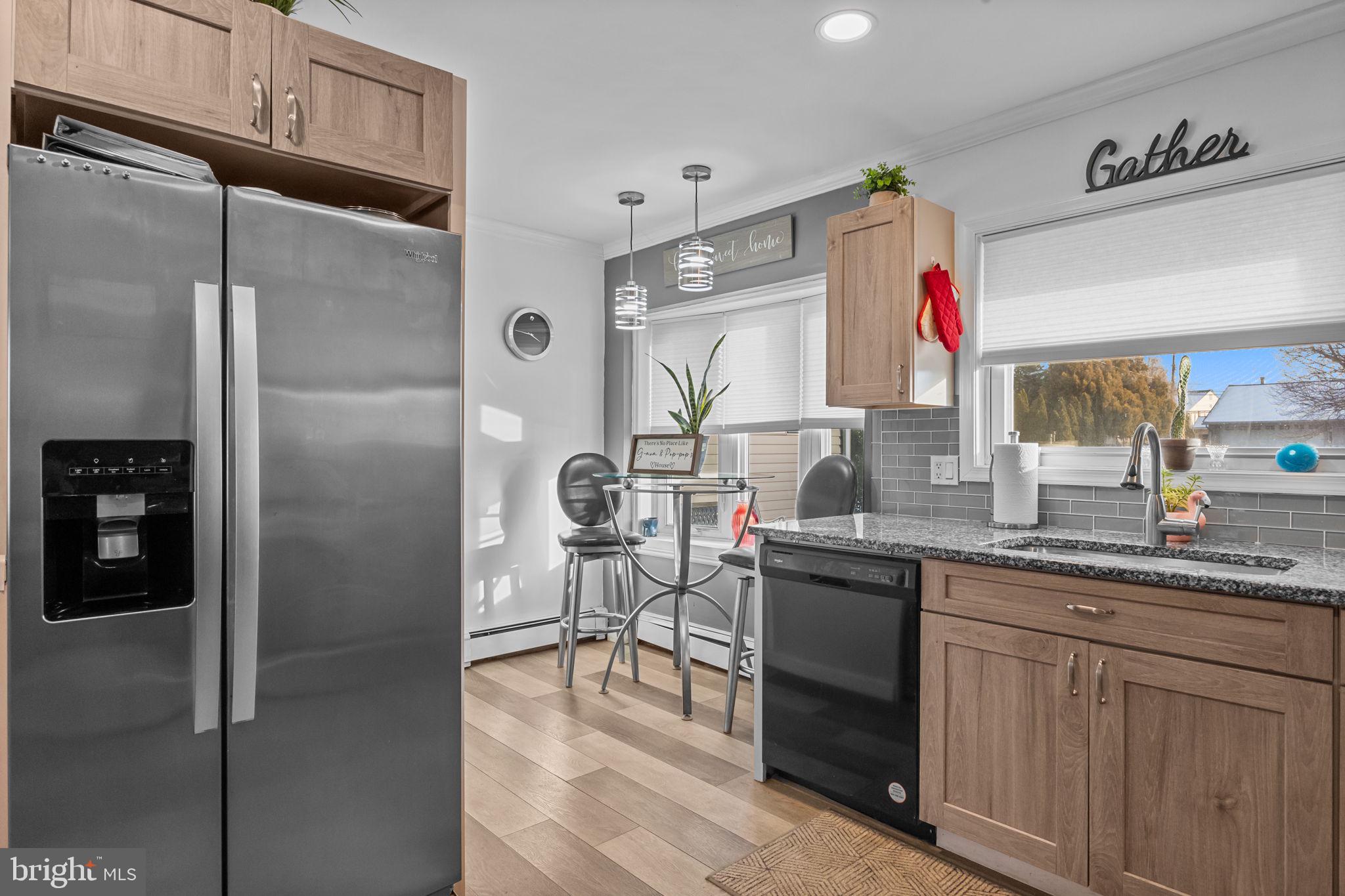 55 Rose Apple Road Levittown, PA 19056 - Photo 13 of 40 a kitchen with granite countertop stainless steel appliances a sink and a refrigerator
