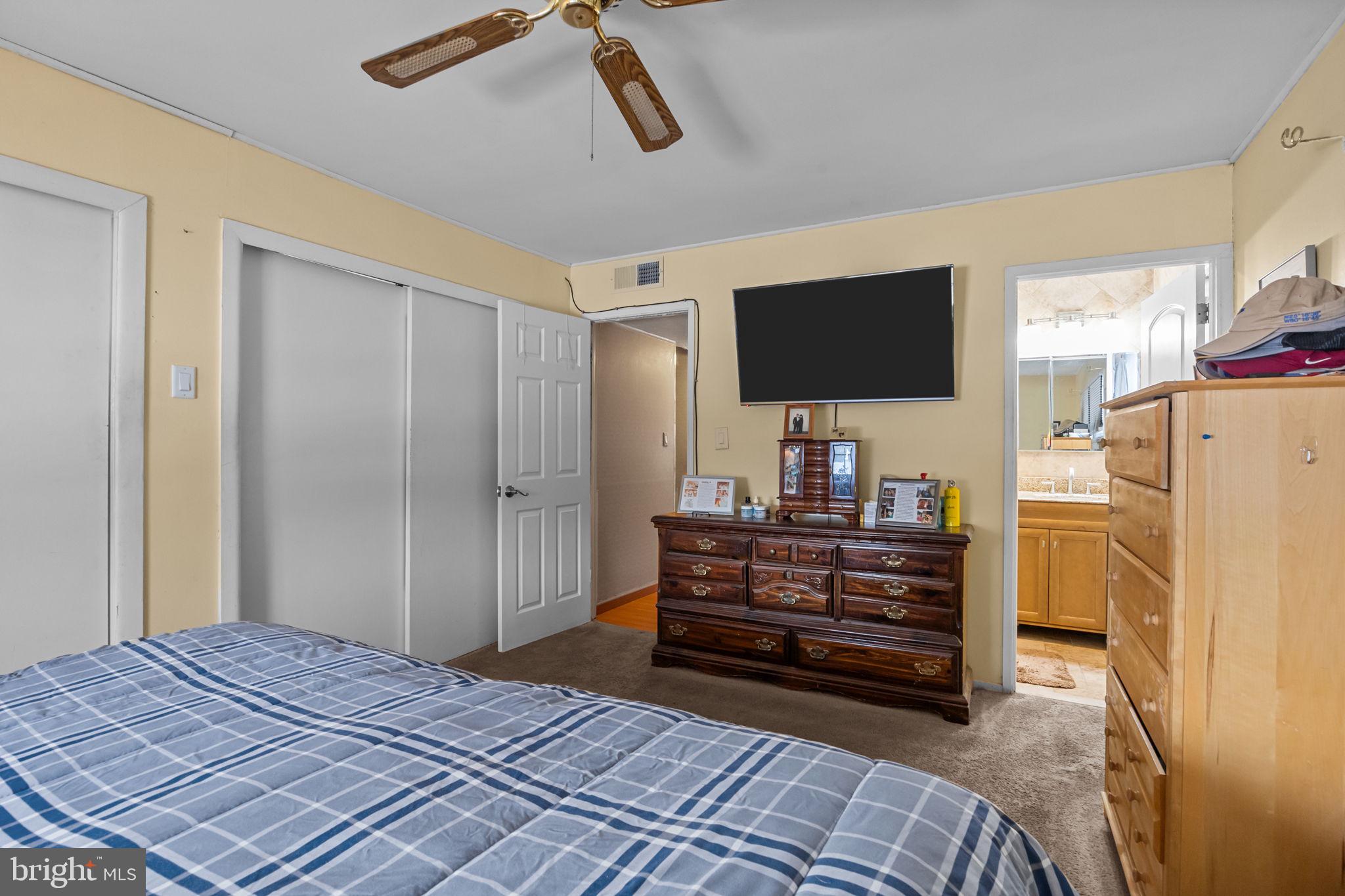 55 Rose Apple Road Levittown, PA 19056 - Photo 21 of 40 a bedroom with a bed and a flat screen tv