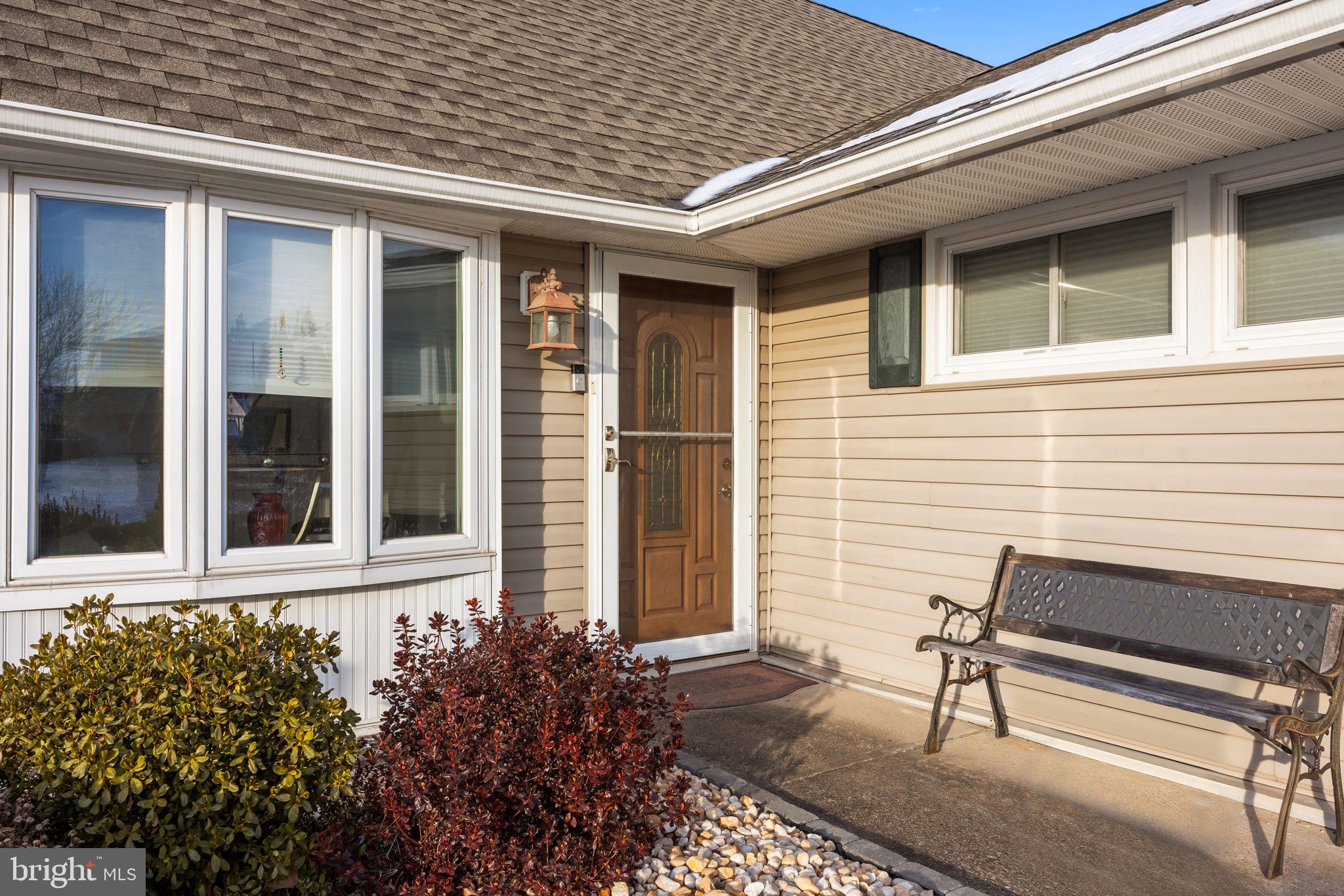 55 Rose Apple Road Levittown, PA 19056 - Photo 4 of 40 a view of brick house with a bench