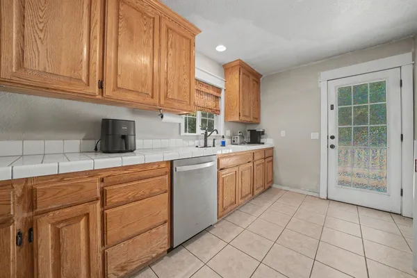 a kitchen with cabinets and window