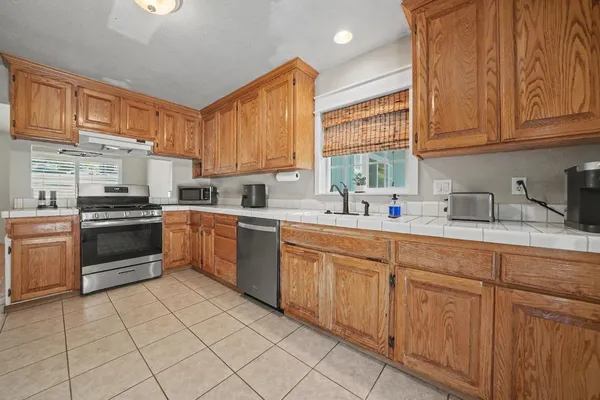 a kitchen with a sink cabinets and window