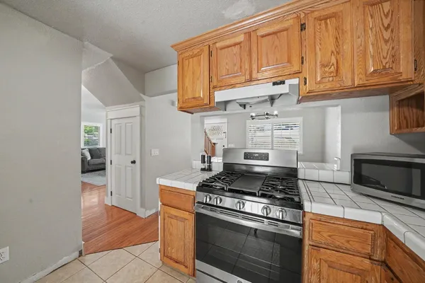 a kitchen with stainless steel appliances granite countertop a stove and a microwave