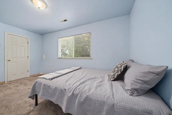 a bedroom with a bed and a window