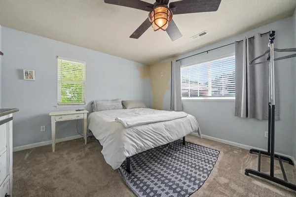 a bedroom with a bed and a window