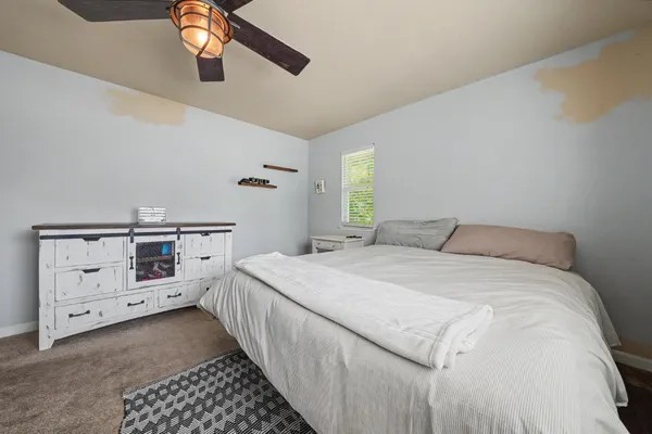 a bedroom with a bed and a baby crib