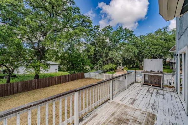 a balcony with wooden floor and fence