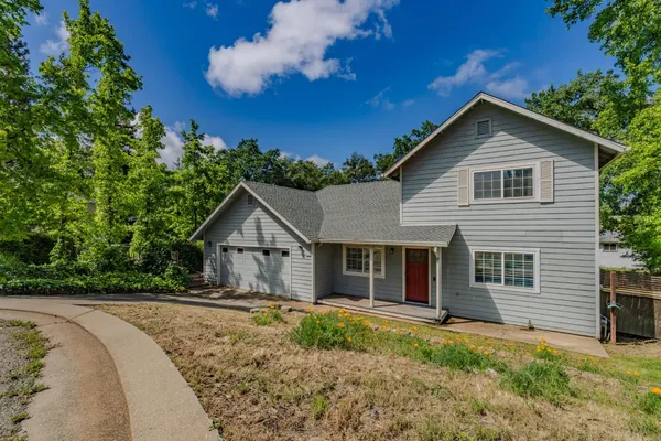 a view of house with backyard and garden