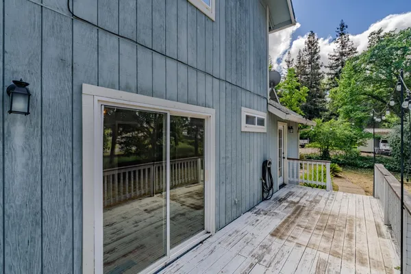 a view of backyard with small cabin and wooden fencing