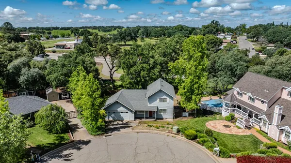 an aerial view of a house with garden space and street view